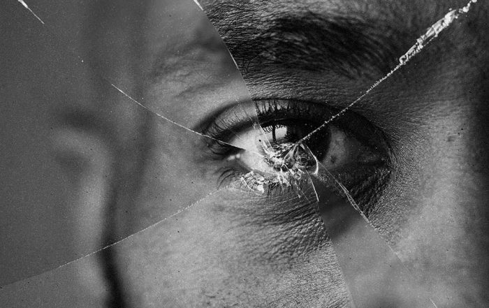Eyes behind broken mirror